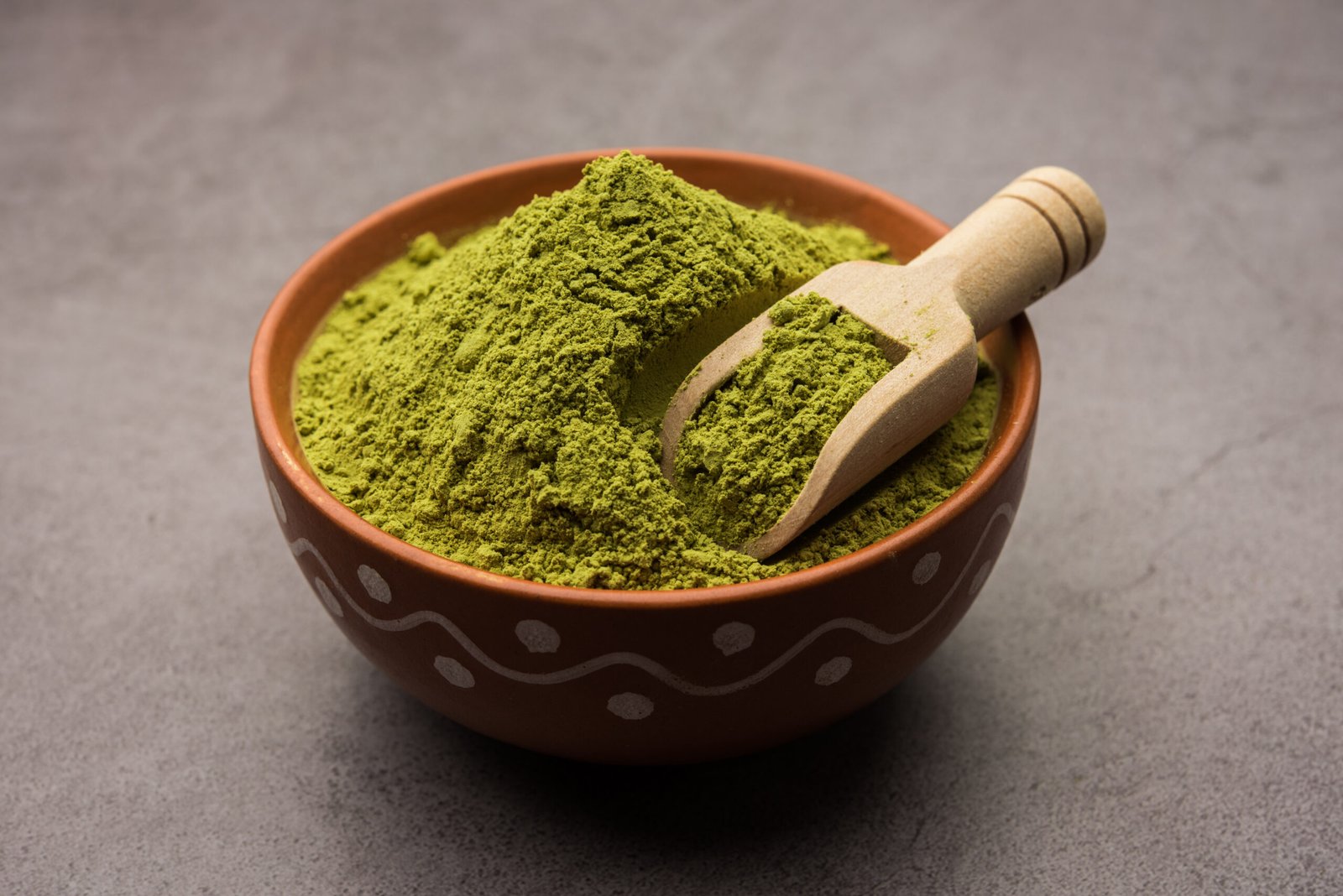 Herbal henna or Mehandi powder in a bowl forming heap, Used for Tattoo or Hair Dye in India